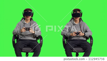 Gamer having fun with rpg games with modern devices over greenscreen background, participating in online gaming competition with friends. Asian man feeling relaxed with vr headset. 112945738