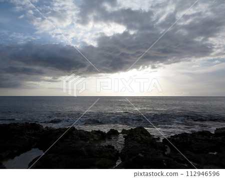 Lava rock shore looking to the ocean on Oahu 112946596