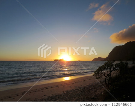 Early Morning Sunrise on Waimanalo Beach over Rabbit Island bursting over the island Early Morning Sunrise on Waimanalo Beach over Rabbit Island bursting over the island 112946665