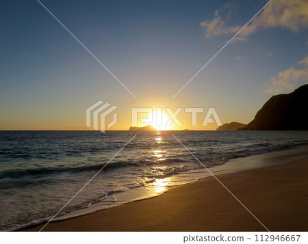 Early Morning Sunrise on Waimanalo Beach over Rabbit Island bursting over the island Early Morning Sunrise on Waimanalo Beach over Rabbit Island bursting over the island 112946667