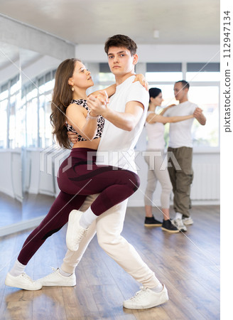 Young men and women dancing latin dances Young men and women dancing latin dances 112947134