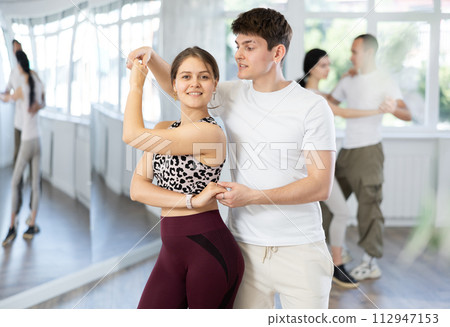 Couples of young men and women dancing waltz 112947153