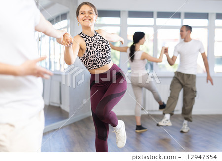 Couples of young men and women dancing twist 112947354