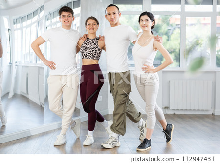 Group of girls and guys rehearsing Irish stepdance in dance studio Group of girls and guys rehearsing Irish stepdance in dance studio 112947431