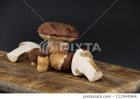 Boletus pinophilus mushrooms over dark background 112948964