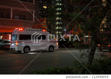 Image of an ambulance transporting people in the city at night Image of an ambulance transporting people in the city at night 112949054