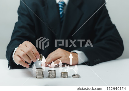 Businessman holding coins stacking with up arrow for financial banking interest rate from money saving and business investment growth from dividend concept. 112949154