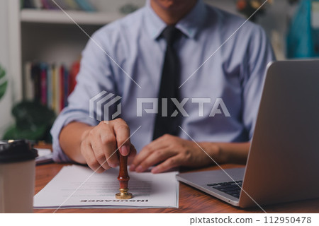 Man stamp rubber approve documents insurance finance certify at office 112950478