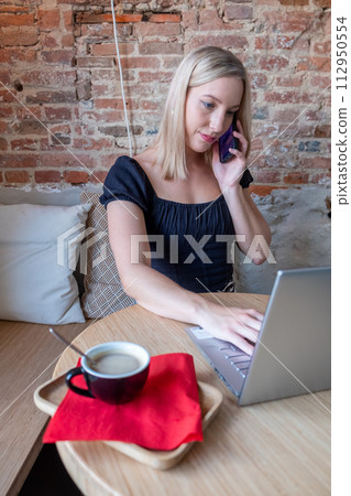 Multitasking Maven: Young Professional Balancing Work and Communication Multitasking Maven: Young Professional Balancing Work and Communication 112950554