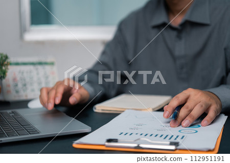 Businessman chart analysis document work financial plan marketing with laptop 112951191