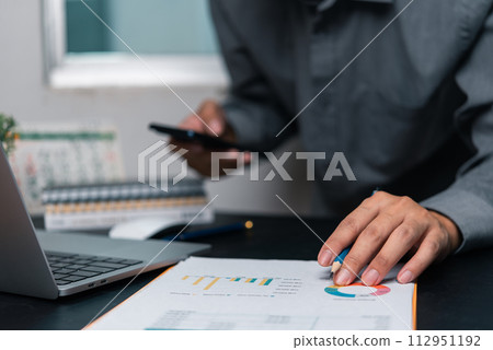 Businessman chart analysis document work financial plan marketing with laptop 112951192