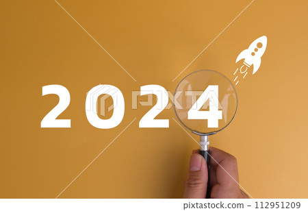 New Year 2024 business planning and strategy concept. Business start up target, marketing financial and research analysis, investment Magnifying glass on background with a number. 112951209