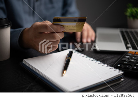 Business man holding credit card and using laptop. Online internet shopping payment. Finance and banking concept. 112952565