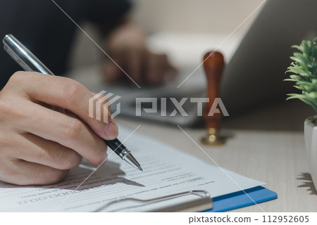 man hands with pen writing paperwork Planning taxes and finance for investment man hands with pen writing paperwork Planning taxes and finance for investment 112952605