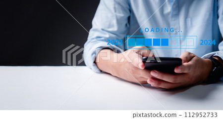 Loading progress bar fills up, symbolizing the transition from 2023 to 2024. Join us in this calendar date transformation, marking the end of one year and the exciting beginning of another. 112952733