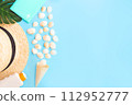 Summer holidays with seashells, palm leaves and straw hat. Blue background with copy space. Top view. Place for text. 112952777