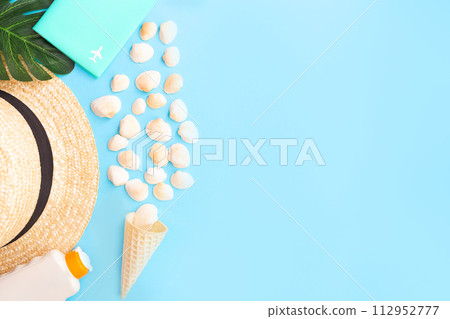 Summer holidays with seashells, palm leaves and straw hat. Blue background with copy space. Top view. Place for text. 112952777