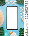 Summer holidays with seashells, palm leaves and straw hat. Smartphone with white screen. Blue background. Top view. Mock up. 112952782