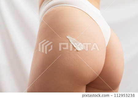 Body care. Woman applying cream on legs and 112953238