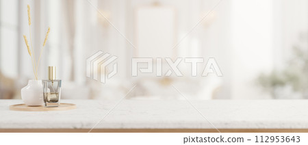 A luxurious white marble tabletop with a space for display products in a modern luxurious bathroom. 112953643