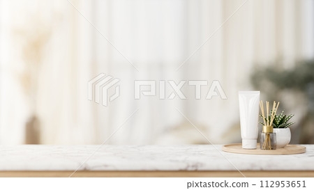 A luxurious toiletries set is placed on a luxury white marble tabletop in a white bathroom. A luxurious toiletries set is placed on a luxury white marble tabletop in a white bathroom. 112953651