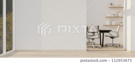 A contemporary office corridor passes through a meeting room with a white wall and a parquet floor. A contemporary office corridor passes through a meeting room with a white wall and a parquet floor. 112953673