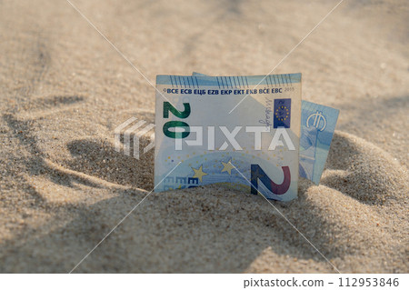 Money 20 euros bills in sandy beach. Concept finance saving money for holiday vacation. Costs in travel holidays 112953846
