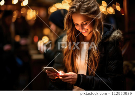 Young female student talking online using a smartphone 112953989