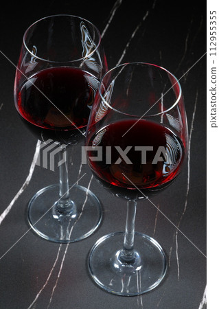 An image of a toast with two wine glasses filled with red wine An image of a toast with two wine glasses filled with red wine 112955355