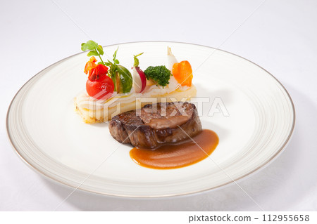 Main beef steak of the French course, fashionable presentation stock image Main beef steak of the French course, fashionable presentation stock image 112955658