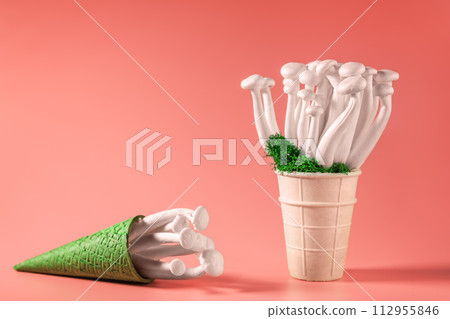 Closeup of a bunch of shimeji mushrooms with green moss in an ice cream cone, on peach fuzz background, superfood, a type of delicious oyster mushroom, healthy food, with copy space 112955846