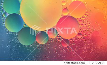 Abstract yellow, green, pink and blue colorful background with oil on water surface. Oil drops in water abstract psychedelic, abstract image. Abstract yellow, green, pink and blue colorful background with oil on water surface. Oil drops in water abstract psychedelic, abstract image. 112955933
