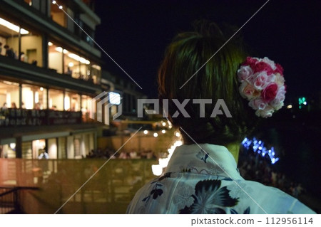 A woman looking at the Kamogawa River A woman looking at the Kamogawa River 112956114