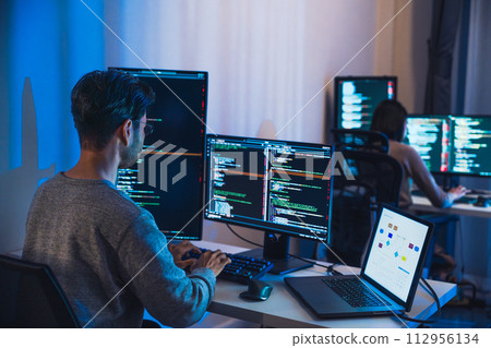asian woman  and Indian man Developer team working  about devops programming software data online  at night in office 112956134