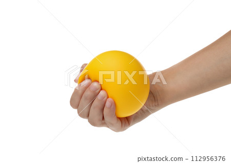 PNG, yellow ball, smiley clenched in hand, isolated on white background. 112956376