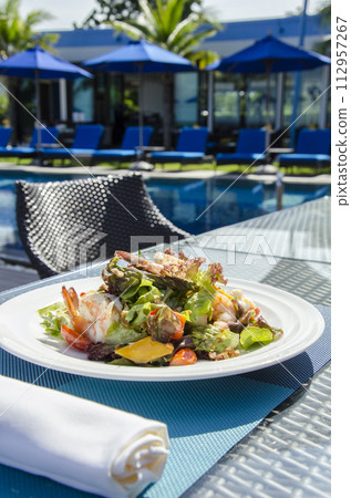 Vegan Yoga Girl Holds Healthy Whole Foods Plant Based Meal with Colorful Greens Quinoa Next to Swimming Pool Vegan Yoga Girl Holds Healthy Whole Foods Plant Based Meal with Colorful Greens Quinoa Next to Swimming Pool 112957267