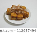 Teriyaki tofu served on a white plate 112957494