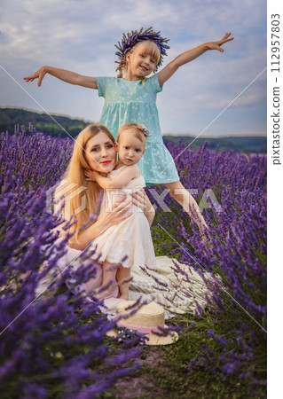 mother with two daughters on a lavender field 112957803