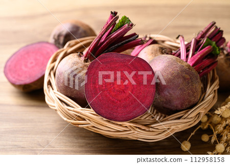 Fresh beetroot in natural basket on wooden background, Food ingredient 112958158
