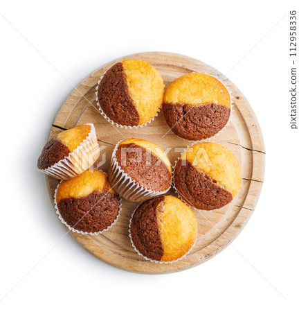 Close Up of a Muffins on cutting board isolated on white background. 112958336