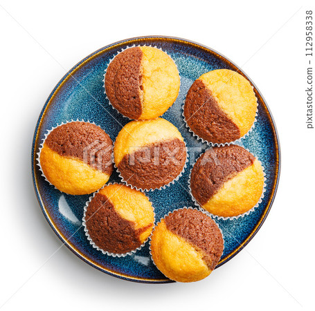 Close Up of a Muffins on plate isolated on white background. Close Up of a Muffins on plate isolated on white background. 112958338