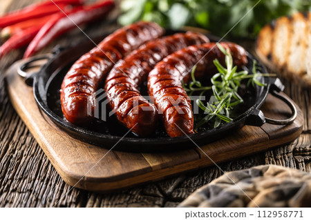 Sausages fried with spices bbq sauce and herbs - Close up 112958771