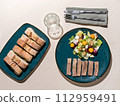 Gourmet Lunch Setup with Sliced Beef Meat, Sliced Baguette and Fresh Salad on Ceramic Plates 112959491