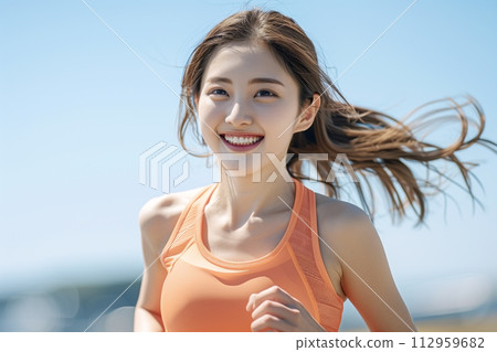 Woman in her 20s jogging outdoors 112959682