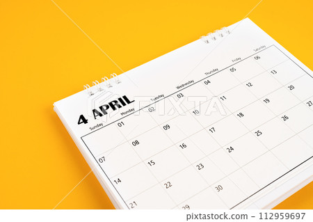 April 2024 desk calendar on yellow color background. April 2024 desk calendar on yellow color background. 112959697