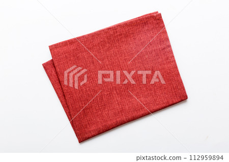 top view with red empty kitchen napkin isolated on table background. Folded cloth for mockup with copy space, Flat lay. Minimal style 112959894