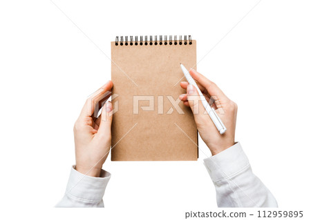 Woman hand with pencil writing on notebook. Woman working on office table. Female hand holding pencil and sketchbook. Mock-up Concept 112959895