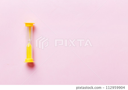 hourglass on the table, sand clock as time passing concept for business deadline, copy space 112959904