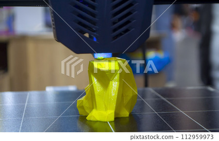 The process of printing an object with 3D printer. 3D printer printing a model from molten plastic. 3D printing. Robotic creation of mold form. Automated creation prototyping of 3D printers technology The process of printing an object with 3D printer. 3D printer printing a model from molten plastic. 3D printing. Robotic creation of mold form. Automated creation prototyping of 3D printers technology 112959973