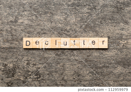 Declutter word written on wood block. Declutter text on cement table for your desing, concept Declutter word written on wood block. Declutter text on cement table for your desing, concept 112959979